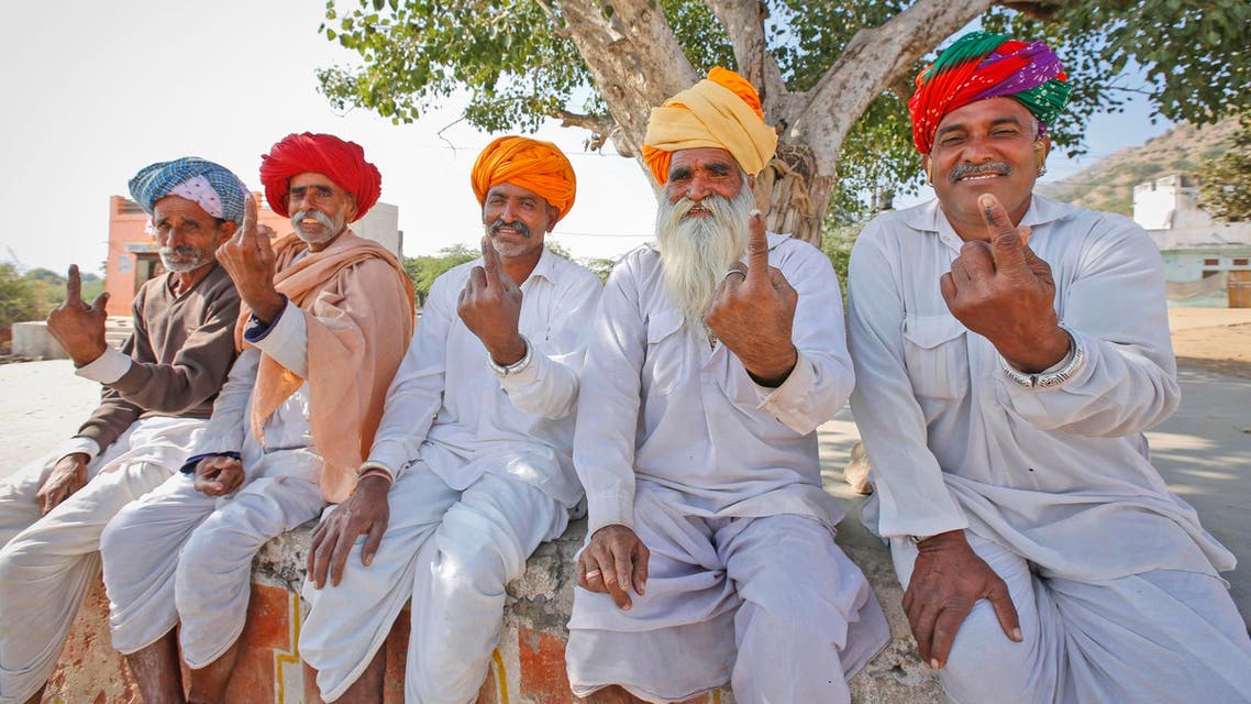 Rajasthani men show the indelible ink mark on their index fingers after casting their vote in village Padampura, near Ajmer on Dec. 7, 2018. (AP)