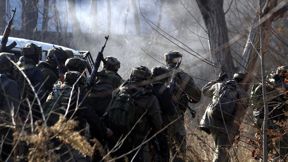 Indian army soldiers take cover near the site of a gun-battle between militants and government forces in Sirnoo Pulwama south of Srinagar on December 15, 2018. (AFP)