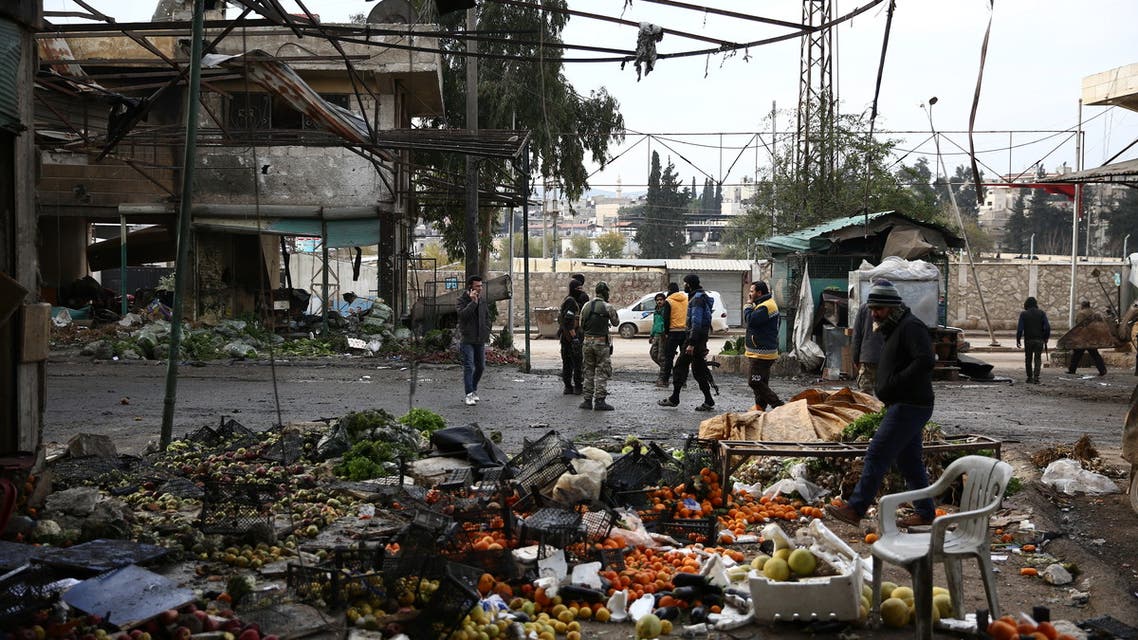 Civilians and Syrian rebel fighters gather after a car bomb reportedly exploded near a position of pro-Turkey fighters in a market in the northern Syrian city of Afrin on December 16, 2018. A car bomb killed at least eight people including four civilians near a pro-Turkey rebel post in the northern Syrian city of Afrin, a British-based war monitor said.