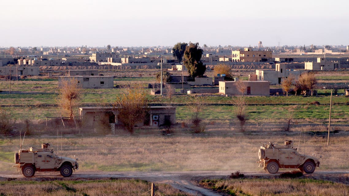 This picture shows US army vehicles supporting the Syrian Democratic Forces (SDF) in Hajin, in the Deir Ezzor province, eastern Syria, on December 15, 2018. Kurdish-led forces seized the Islamic State's main hub of Hajin on December 14, a milestone in a massive and costly US-backed operation to eradicate the jihadists from eastern Syria. The Syrian Democratic Forces secured Hajin, the largest settlement in what is the last pocket of territory controlled by IS, the Syrian Observatory for Human Rights said.