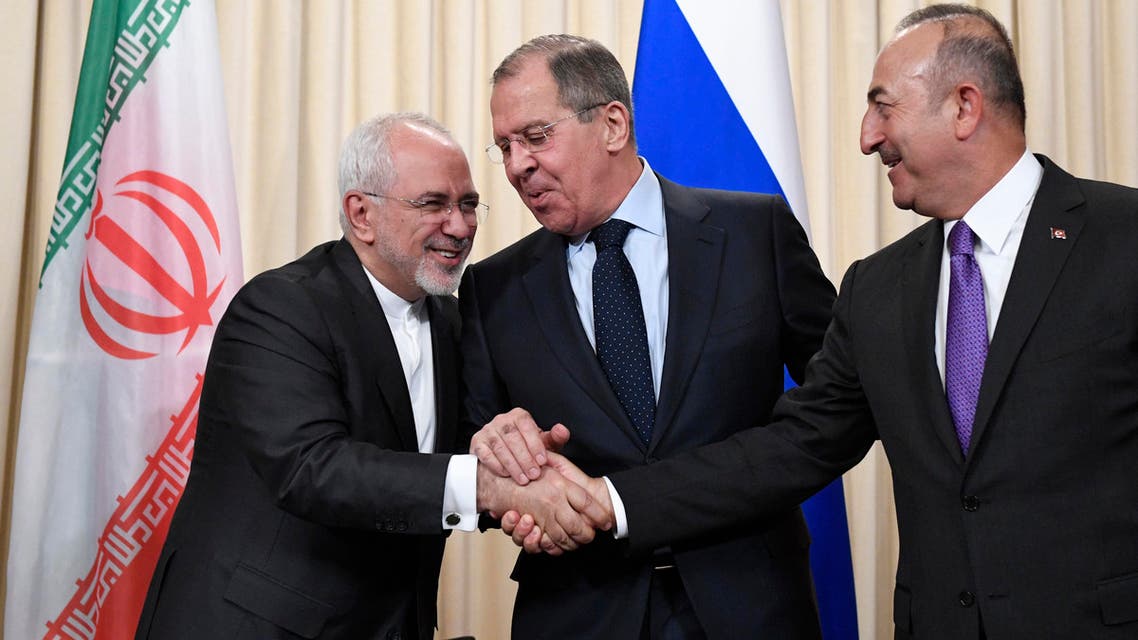 Russian Foreign Minister Sergei Lavrov (C), his Iranian counterpart Mohammad Javad Zarif (L) and Turkish Foreign Minister Mevlut Cavusoglu shake hands at the end of a joint press conference following their talks in Moscow on April 28, 2018.