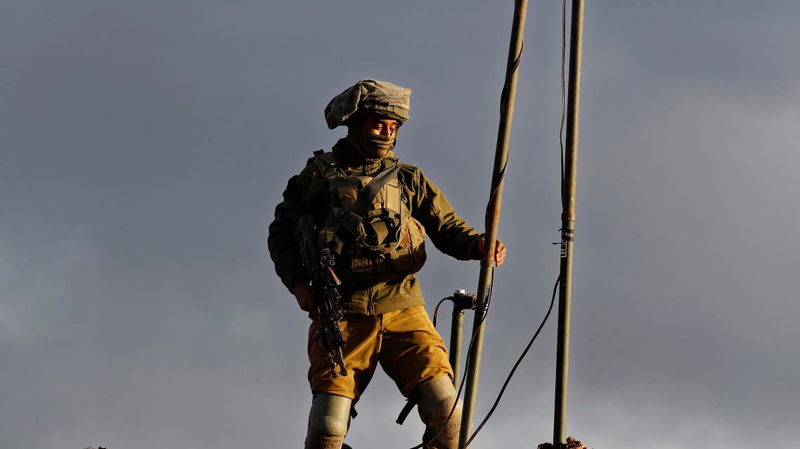 An Israeli soldier sets up a camera at one of their new position, near the Lebanese southern border village of Mays al-Jabal, Lebanon, on Dec. 13, 2018. (AP)
