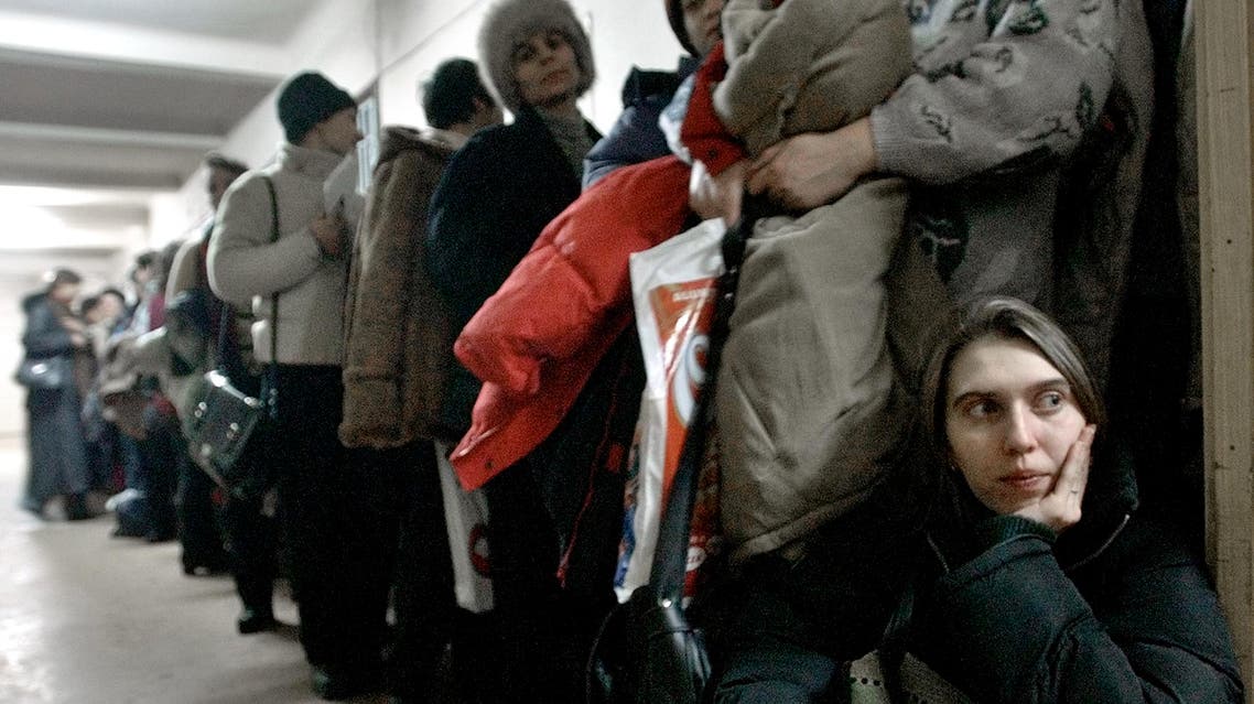 A Romanian woman at the International Office for Migration in Bucharest, Romania, on Jan. 28, 2004, waiting in a line to apply for a job in Spain. (AP)