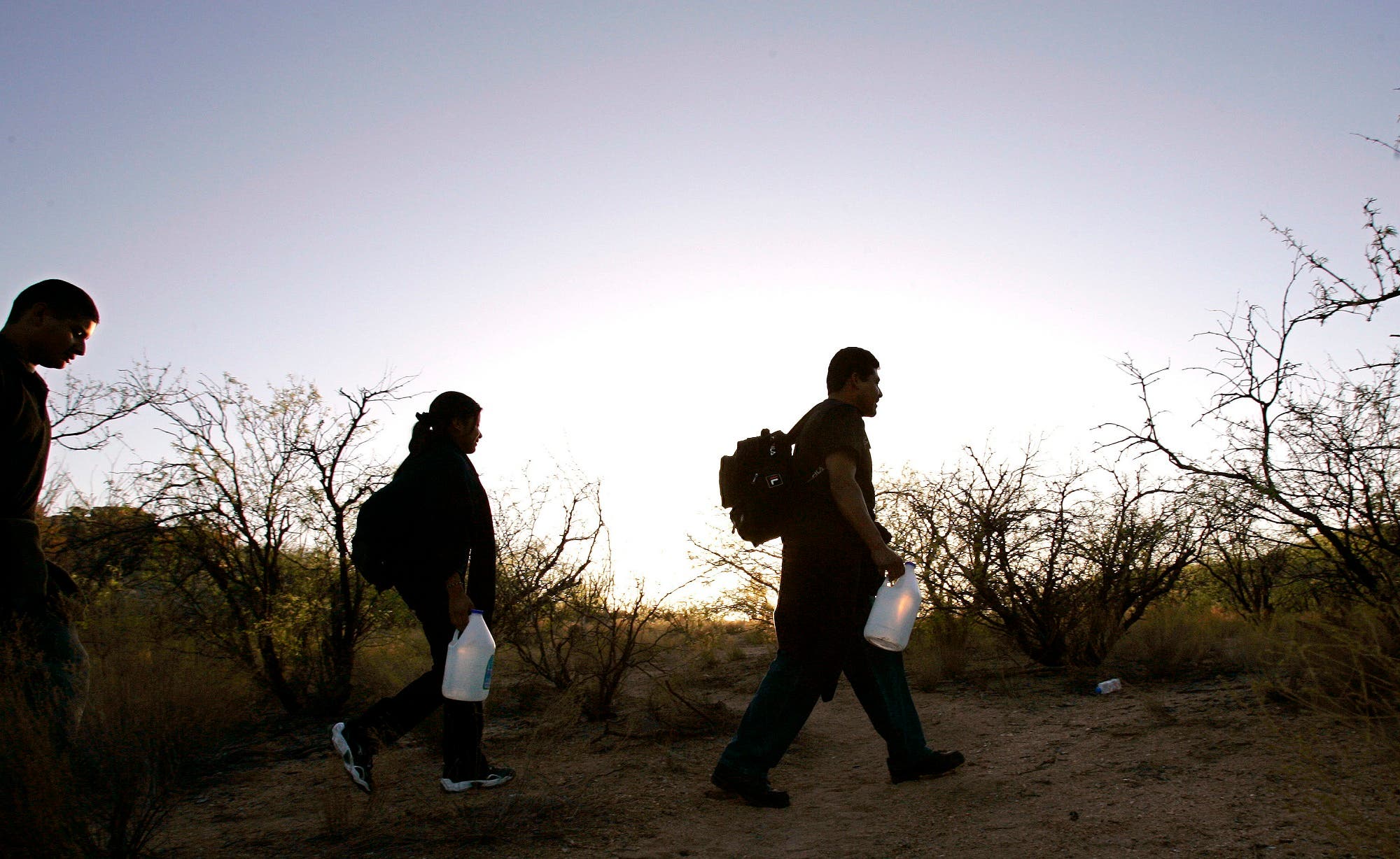 A group of migrants cross the desert between Sasabe, Mexico, and Sasabe, Arizona on April 25, 2006. (AP)