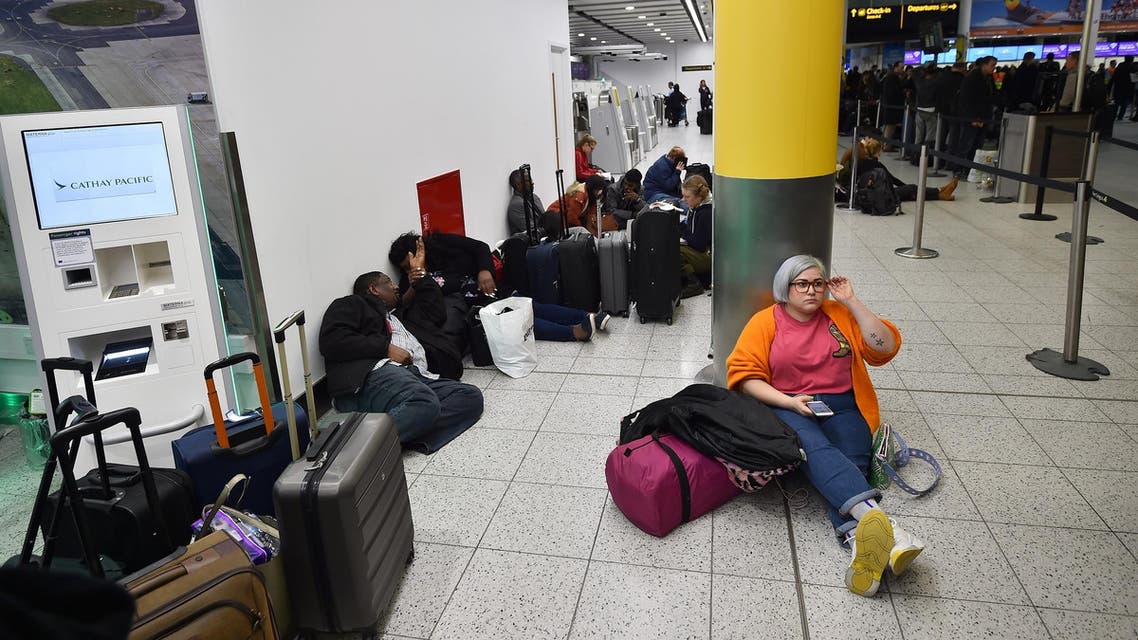 Passengers wait at London Gatwick Airport on December 20, 2018 after all flights were grounded. (AFP)