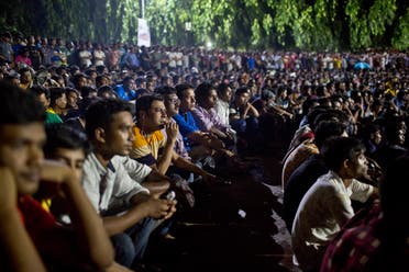 Bangladeshi people watch the live broadcast of the World Cup final match between France and Croatia on a screen in Dhaka, Bangladesh. (AP)