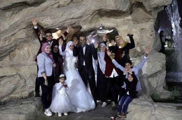 Nadia Mohammad Salem and her husband celebrate with family on their wedding day, in Cairo. (Reuters)