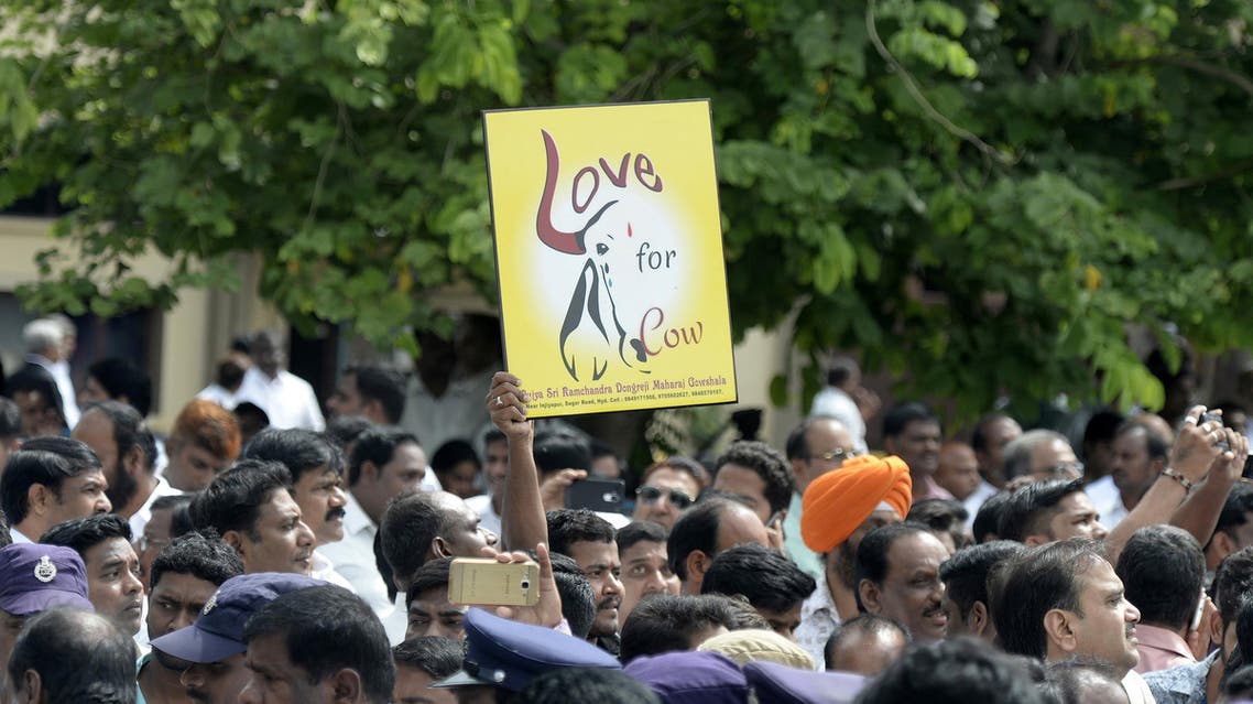 A BJP supporter holds a sign depicting a cow ahead of a meeting with cabinet members in Hyderabad on July 4, 2017. (AFP)