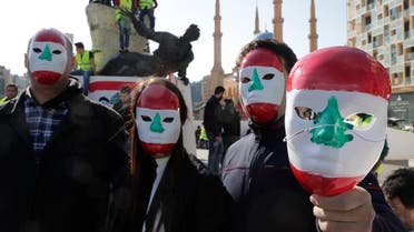 Anti-government protesters inspired by the French movement "Yellow Vests" (Gilets jaunes) hold masks painted with the Lebanese flag demonstrate in Martyr's square. (AFP)