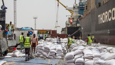 Workers unload NOGs’ food ratios from the Thorco Liva ship before loading trucks at Berbera port of Somaliland on July 21, 2018. (AFP)