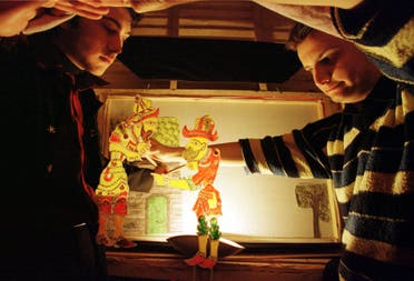 Young Karagoz apprentices show the shadow puppets in Istanbul on January 5, 2000. (AP)