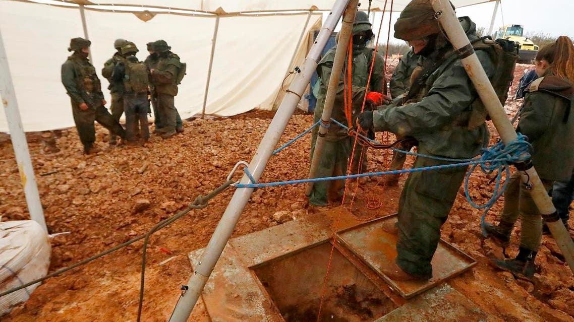 A picture taken on December 19, 2018 during a guided tour by the Israeli army shows an Israeli soldier operating a pulley while standing outside an entry point made by the army to intercept a tunnel which reportedly connects between Lebanon and Israel. (AFP)