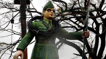 Electric wires are entangled around a statue of Subhash Chandra Bose at road crossing during Cyclone Phailin in Berhampur, India, on Oct. 13, 2013. (AP)