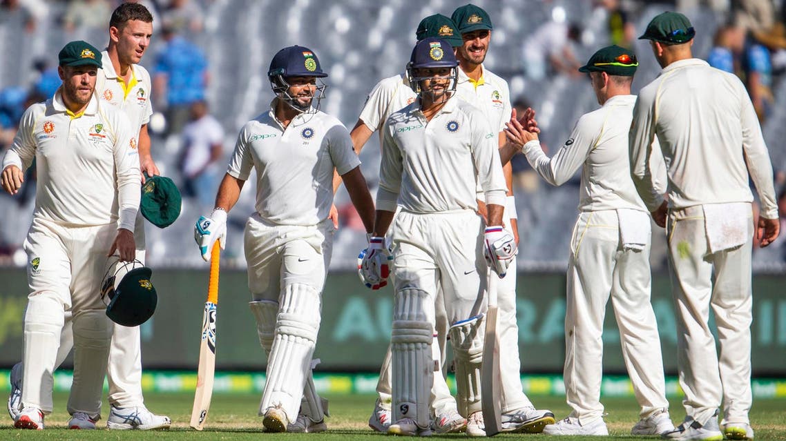India’s Rishabh Pant, center left, and Mayank Agarwal, center right, walk off the field at the end of play in Melbourne on Dec. 28, 2018. (AP)