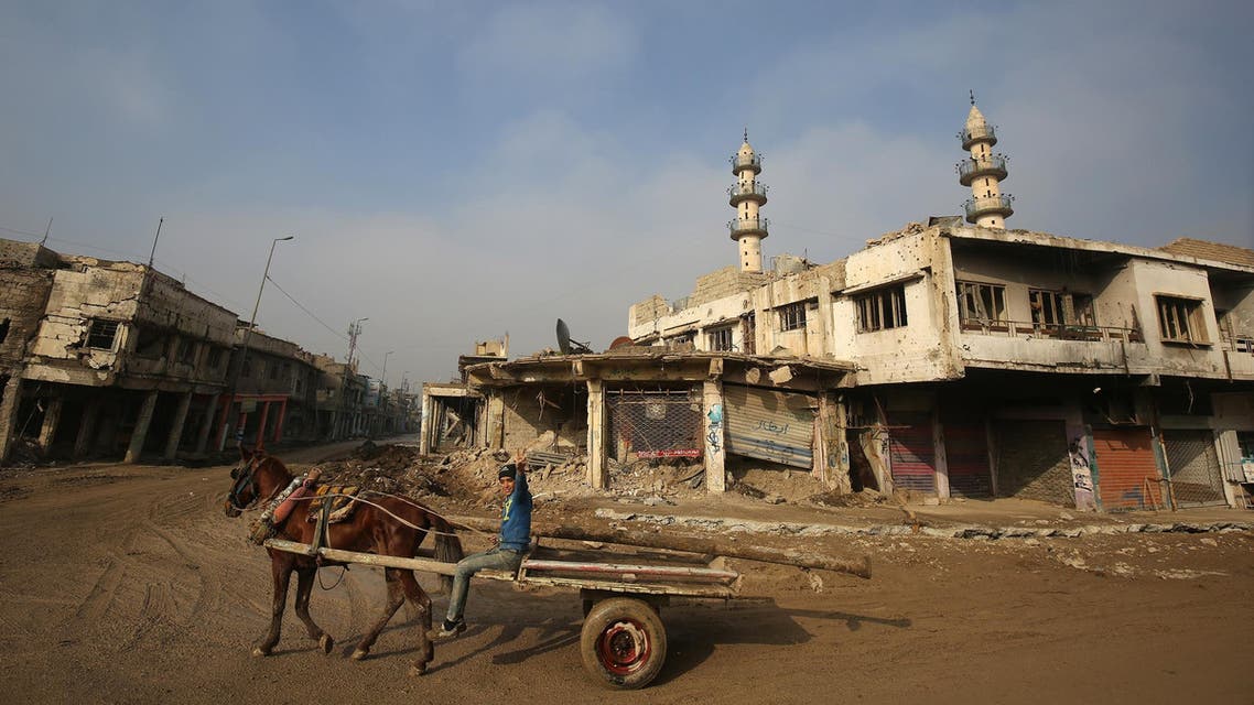 An Iraqi boy rides a horse cart in Mosul on December 23, 2018. (AFP)