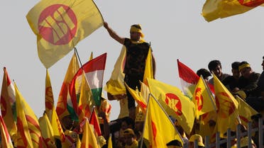 Iraqi Kurds wave flags during an election rally in Arbil on September 25, 2018. (AFP)