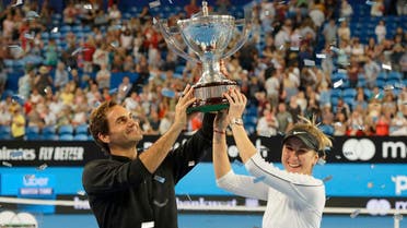 Switzerland's Federer and Bencic hold the trophy after winning the final against Germany at the Hopman Cup. (AP)