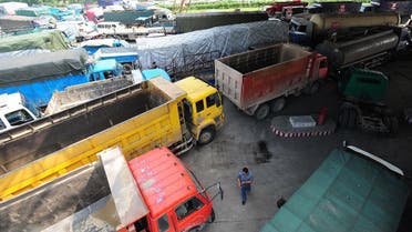 A long queue of trucks wait to fill up with diesel at a petrol station in Wuhan, central China's Hubei province. (AFP)