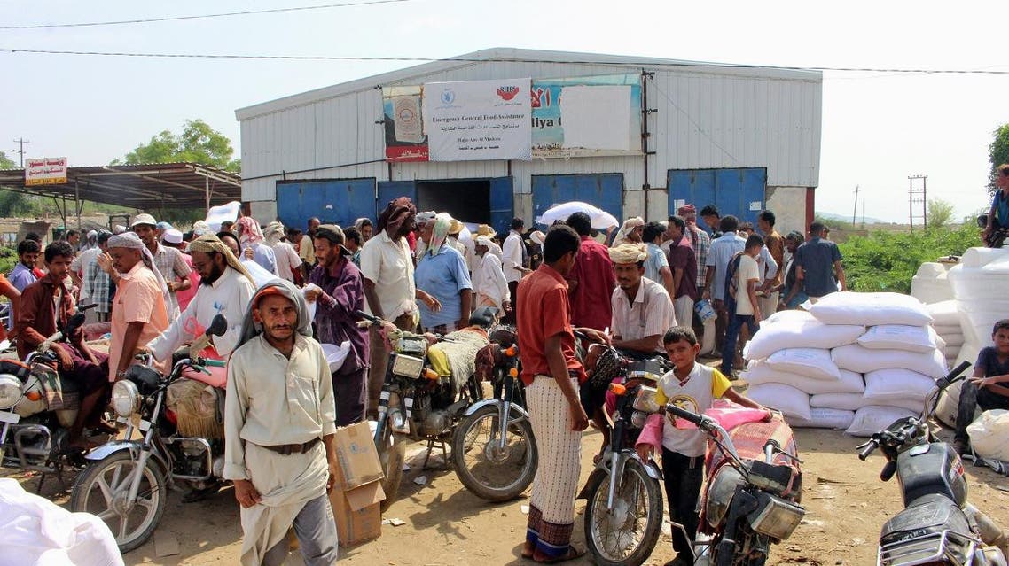 Yemenis displaced from the port city of Hodeidah receive humanitarian aid donated by the World Food Programme (WFP) in the northern province of Hajjah on September 25, 2018. (AFP)