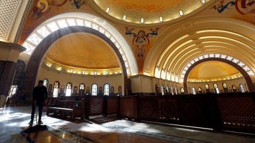 A worker cleans the interior of the new Coptic Cathedral of the Nativity at the New Administrative Capital (NAC) east of Cairo. (Reuters)