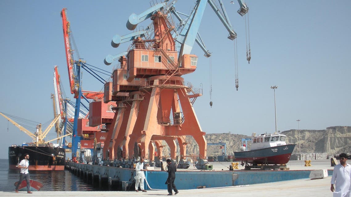 Pakistani laborers walk through Gwadar port on October 4, 2017. (AP)