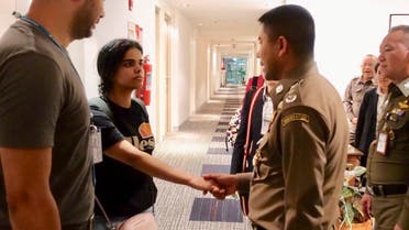 Thai immigration authorities greet Rahaf al-Qunun at a hotel inside Suvarnabhumi Airport in Bangkok on January 7, 2019. (Reuters)