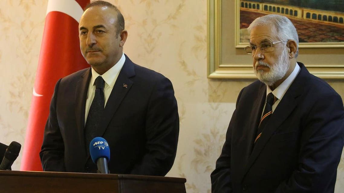 Libyan Foreign Minister Mohamed Taher Siala (L) and his Turkish counterpart Mevlut Cavusoglu (R) take part in a press conference at Mitiga International Airport near the Libyan capital Tripoli, on December 22, 2018. (AFP)