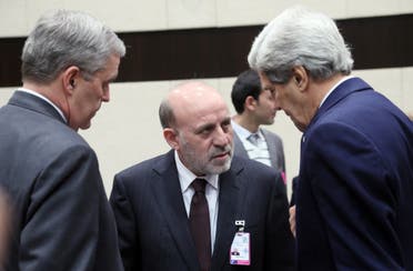 US Secretary of State John Kerry, right, speaks with Mohammed Umer Daudzai, center, during a meeting of NATO foreign ministers in Brussels on Dec. 4, 2013. (AP)