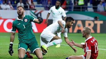 Lebanon’s goalkeeper Mehdi Khalil (left), reacts after Saudi midfielder Hussain al-Mogahwi, (center), score his goal during the AFC Asian Cup group E match  on January 12, 2019. (AP)