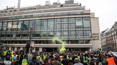 Yellow vest protestors gather outside AFP HQ in Paris (AFP)