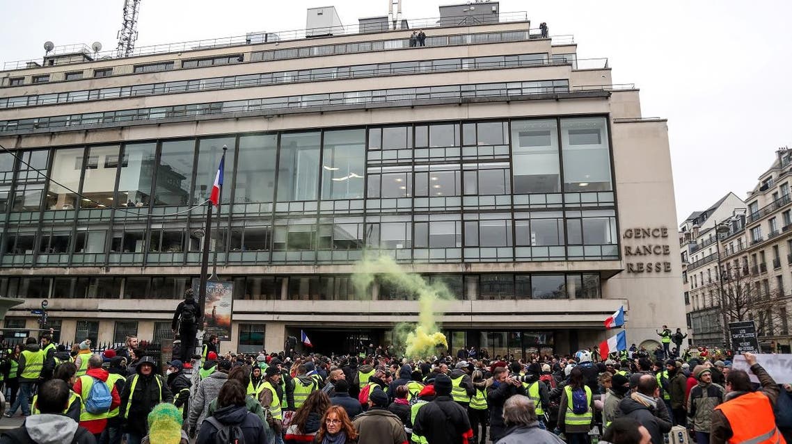 Yellow vest protestors gather outside AFP HQ in Paris (AFP)