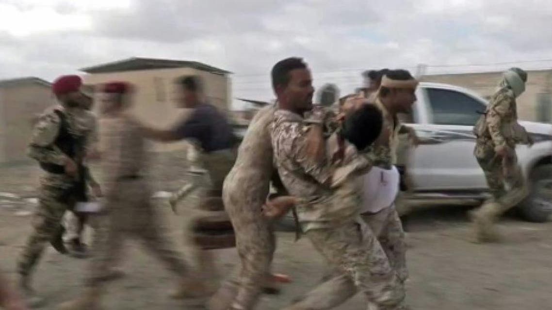 An image grab taken from a video obtained by AFPTV shows a wounded Yemeni soldier being carried by comrades after a rebel drone strike hit Al-Anad air base in Yemen's government-held southern Lahj province on January 10, 2019 An image grab taken from a video obtained by AFPTV shows a wounded Yemeni soldier being carried by comrades after a rebel drone strike hit Al-Anad air base in Yemen's government-held southern Lahj province on January 10, 2019 AFP