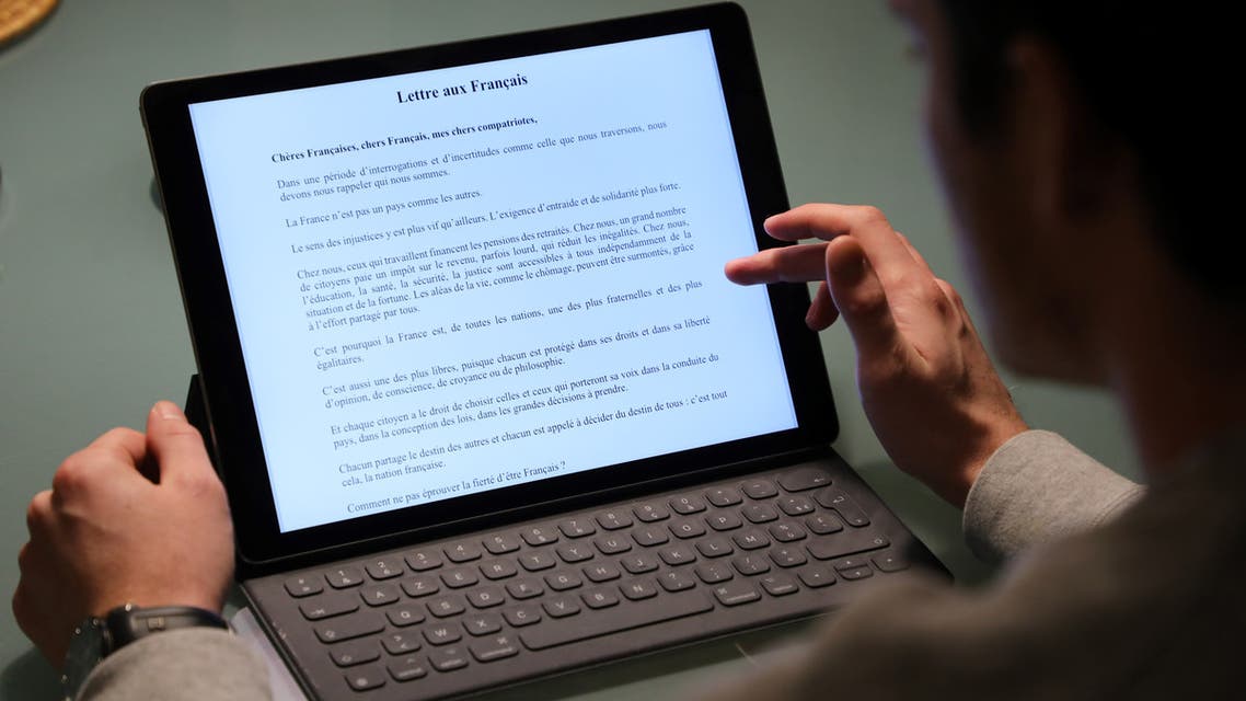 A man reads a portion of a "Letter to the French People" (Lettre aux Francais) written by French President Emmanuel Macron, on January 13, 2019, in Paris. Macron published a personal letter to households spelling out his goals for the "great national debate", a public consultation beginning on January 15, 2019, to discuss the "essential questions" facing the nation after nearly two months of violent so-called yellow vest protests.