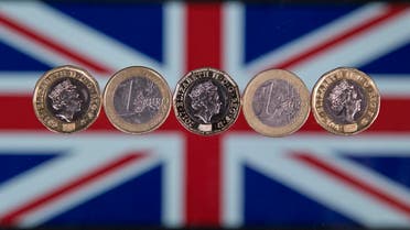 British one pound sterling coins and one Euro coins are arranged in front of a Union flag for a photograph in London on December 14, 2017.  Justin TALLIS / AFP