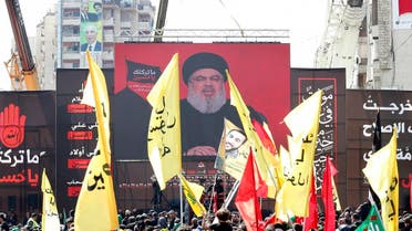 Supporters of Lebanon's Shiite movement Hezbollah gather near a giant poster of their leader Hassan Nasrallah during a ceremony to mark Ashura on September 20, 2018 in Beirut. Ashura commemorates the death of Imam Hussein, grandson of the Muslim faith's prophet Mohammed, who was killed by the armies of his rival Yazid over the succession for the caliphate near Karbala in 680 AD. ANWAR AMRO / AFP