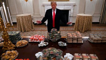President Donald Trump talks to the media about the table full of fast food in the State Dining Room of the White House in Washington, Monday, Jan. 14, 2019, for the reception for the Clemson Tigers. (AP)
