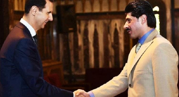حسام القاطرجي في صورة سابقة مع الأسد