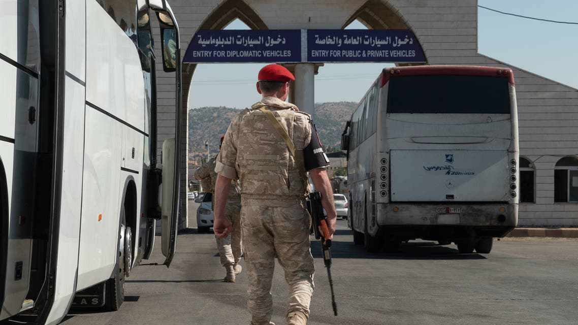 A bus transporting Syrian refugees back from Lebanon is seen on the border between Syria and Lebanon on August 13, 2018 in Jdaidat Yabous, during a guided tour with the Russian army. Dozens of Syrian refugees left Lebanon by bus on August 13 in the latest of a wave of returns to their war-torn country, Lebanese authorities said.