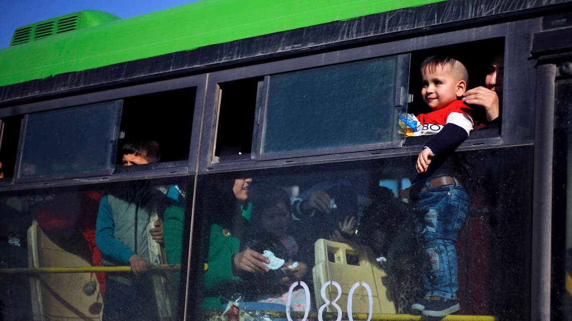 A refugee child looks out of a bus window that will take them home to Syria, in the northern Beirut suburb of Burj Hammoud, Lebanon, Thursday, Jan. 24, 2019. Hundreds of Syrian refugees in Lebanon have gone back to Syria. Lebanon is hosting about 950,000 registered Syrian refugees. That's according to the U.N. refugee agency. The government estimates the true number of Syrian refugees in the country at 1.5 million. (AP Photo/Bilal Hussein)
