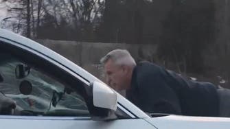 Man clings to moving SUV in rage episode caught on video