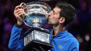 Serbia's Novak Djokovic kisses his trophy after winning the match against Spain's Rafael Nadal. (Reuters)
