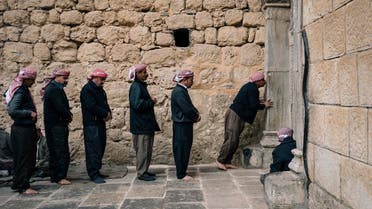 Men stand in line to enter a temple in Lalish, the holiest site of the Yazidi religion. (AFP)