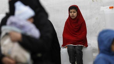 A Syrian girls looks on as aid items to cope with the winter weather are delivered to the al-Hol refugee camp. (File photo: AFP)