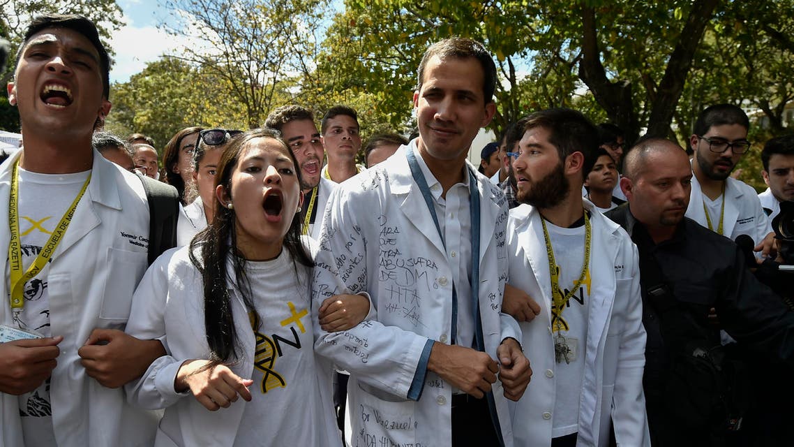 Opposition leader and self-proclaimed "acting president" Juan Guaido (C), marches surrounded by students during a protest he convened against the government of President Nicolas Maduro, outside Venezuela's Central University (UCV) in Caracas, on January 30, 2019. (AFP)