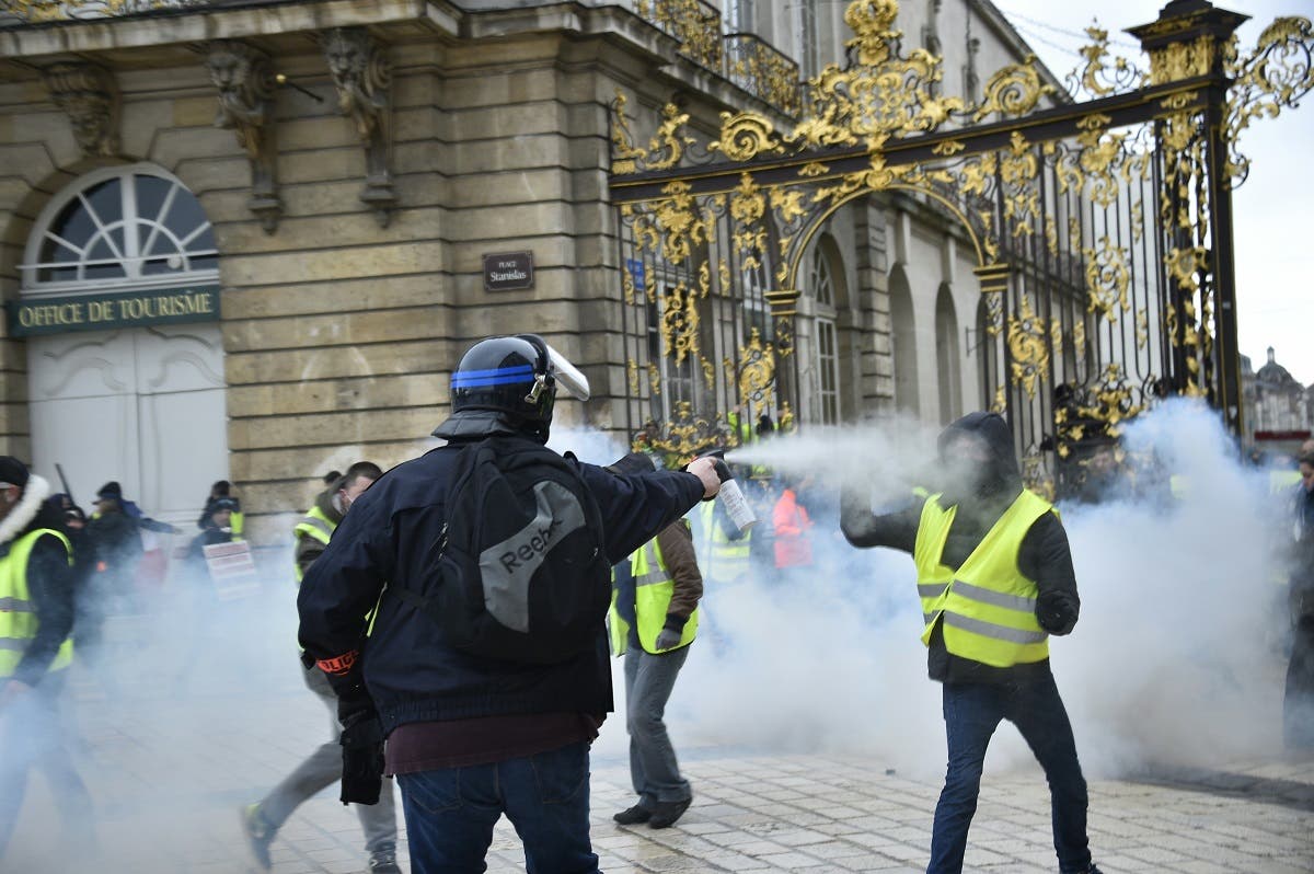 A plain-clothes policeman uses pepper-spray on a “Yellow Vest” (Gilets Jaunes) protester on February 2, 2019, in Nancy, eastern France. (AFP)