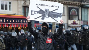 A protester holds up a sign against the use of non-lethal hand-held weapons (LBD40), on the sidelines of a march called by ‘Yellow Vest’ protesters in Paris on February 2, 2019. (AFP)
