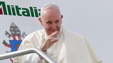 Pope Francis waves as he boards a plane at Fiumicino airport on his way to a three-day visit to the United Arab Emirates. (AFP)