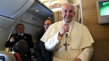 Pope Francis speaks to reporters aboard a plane on the way to Abu Dhabi. (Reuters)
