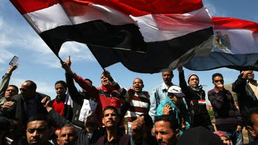 Protesters wave Egyptian flags at Cairo’s Tahrir Square as hundreds demonstrate against sectarianism on March 11, 2011. (AFP)