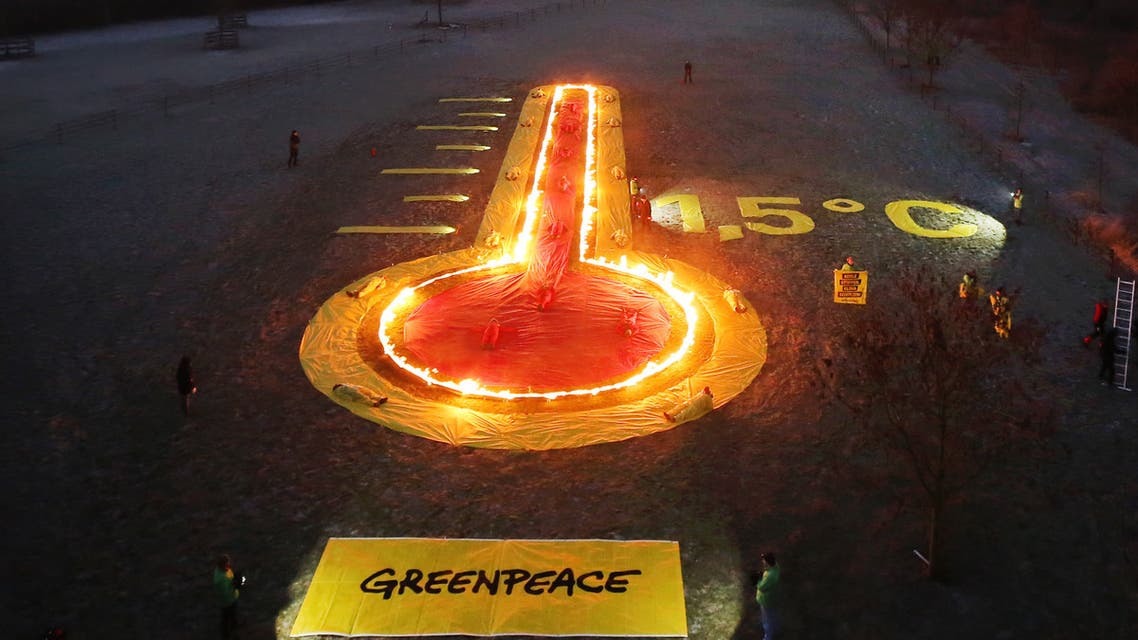 Greenpeace activists have set up an installation depicting a thermometer in front of the Niederaussem lignite-fired power station in Rommerskirchen, western Germany, in a protest on January 22, 2019 against the burning of fossil fuels provoking global warming, asking to limit the rise of global temperatures to 1,5 degrees Celsius.